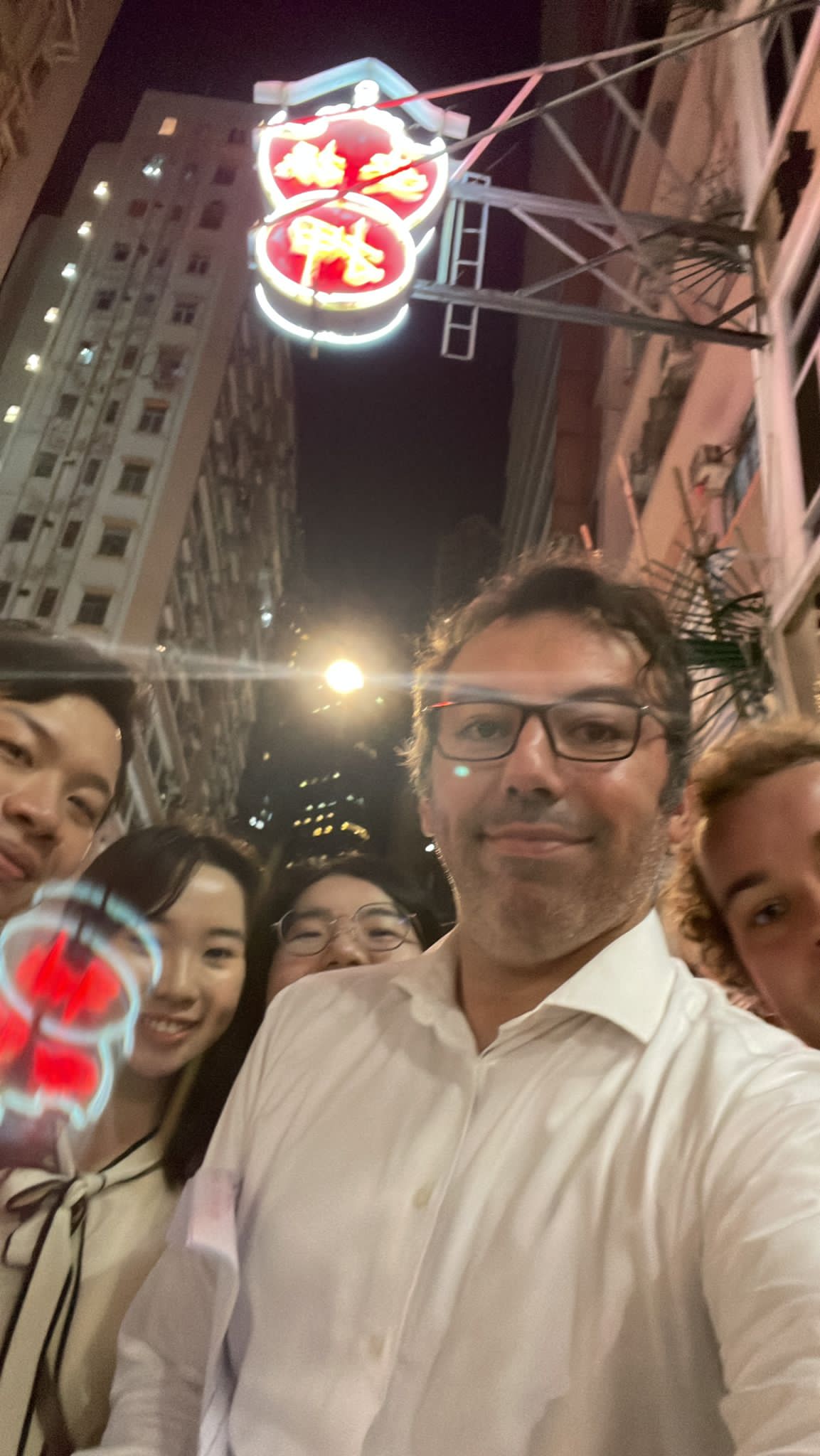 Team finding a neon sign in a corporate team building challenge