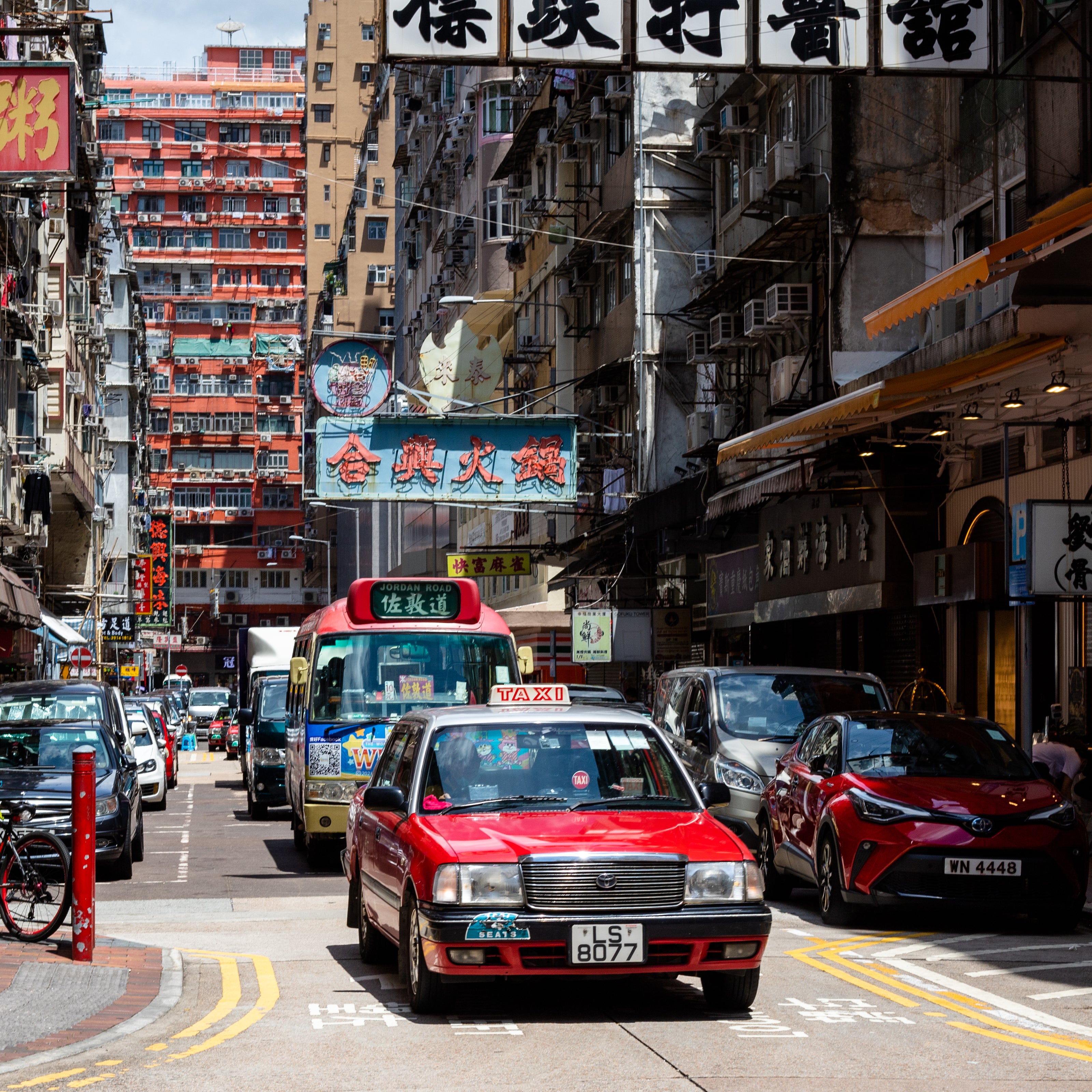 Red taxi and red minibus in a hong kong street
