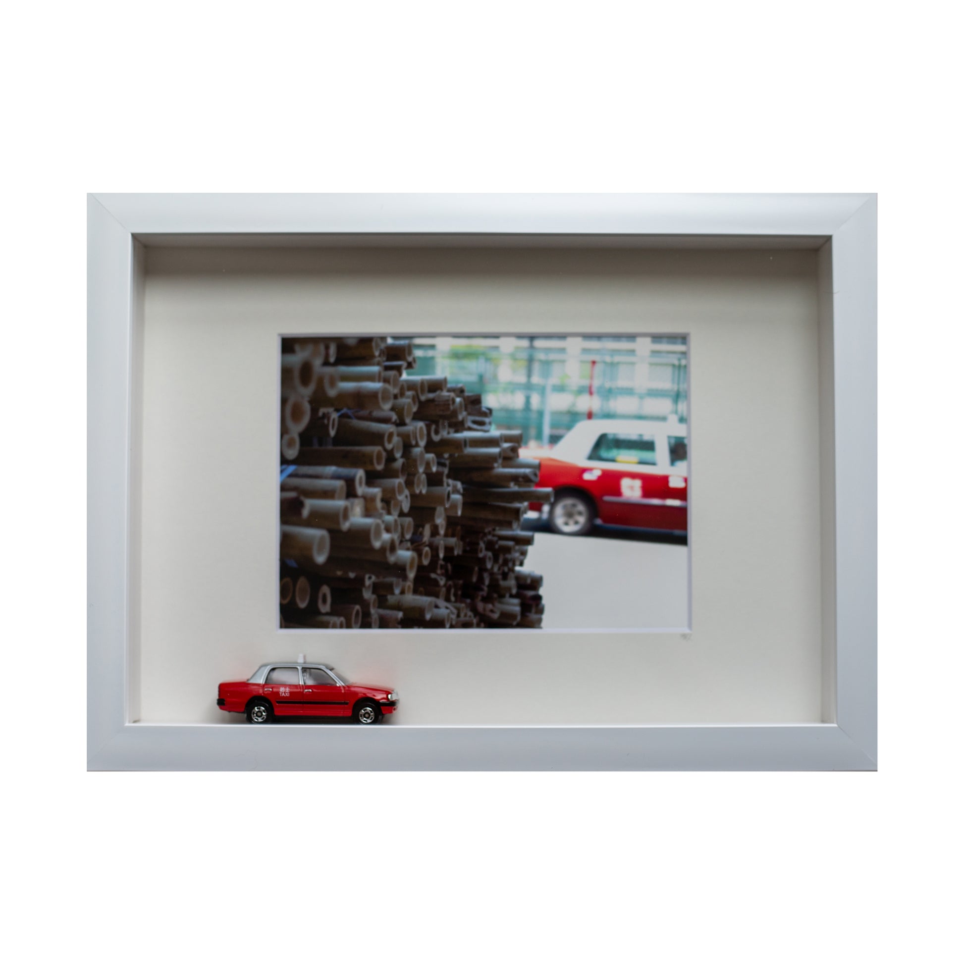 White frame of bamboo taxi with miniture taxi toy 